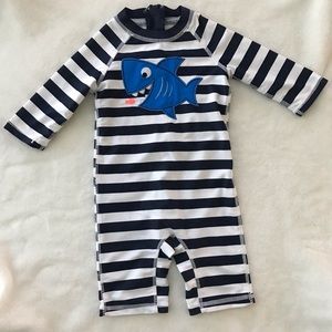 Blue and white striped shark rash guard